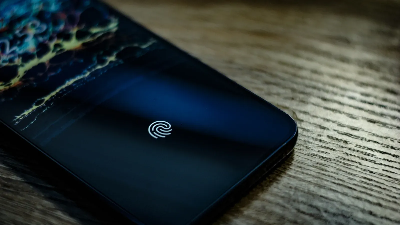 A phone screen showing an in-display fingerprint sensor icon