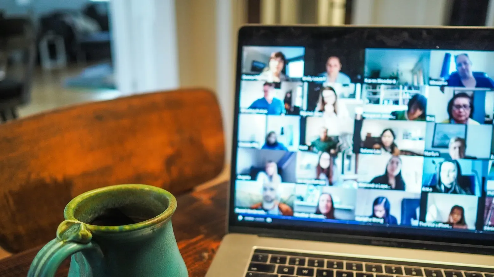 A laptop on a video call with a group of colleagues
